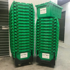 Two stacks of green plastic moving totes